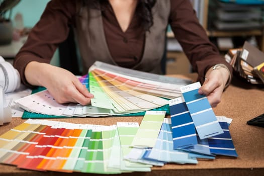 Close up of architect with color palette on her desk