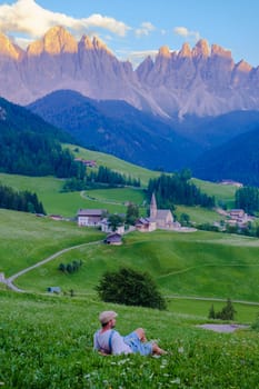 Men viewing the landscape of Santa Maddalena Village in Dolomites Italy