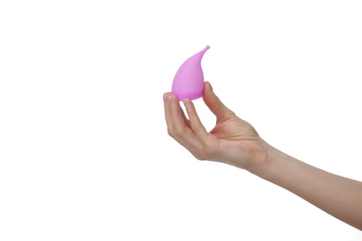 Pink menstrual cup. Close up of woman hand holding menstrual cup over white background. Women health concept, zero waste alternatives