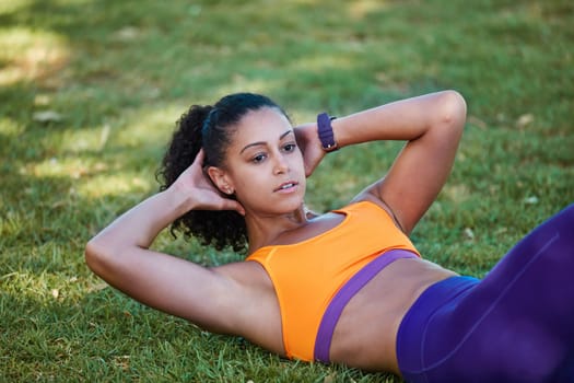 Never give up on yourself. a sporty young woman doing sit ups as part of her exercise routine.