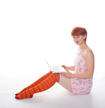 Red Girl in stripe socks with laptop on white background