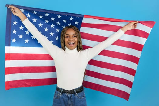 Proud african woman raising a north american flag