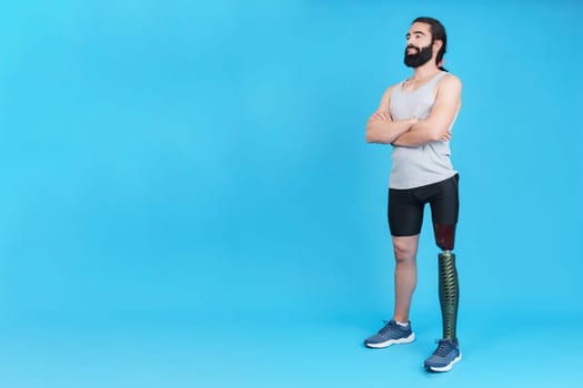 Man crossing arms standing with a leg prosthesis