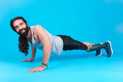 Smiley man with a prosthetic leg doing push-ups