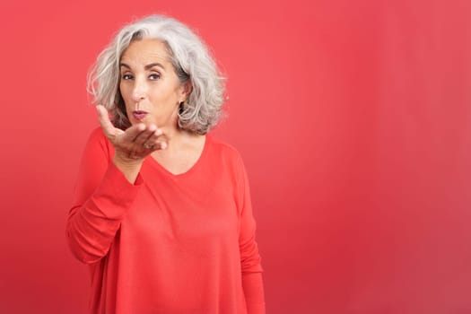 Mature woman blowing a kiss to the camera