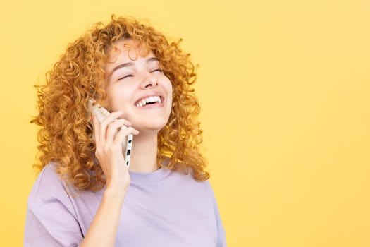 Woman talking to the mobile while smiling with eyes closed