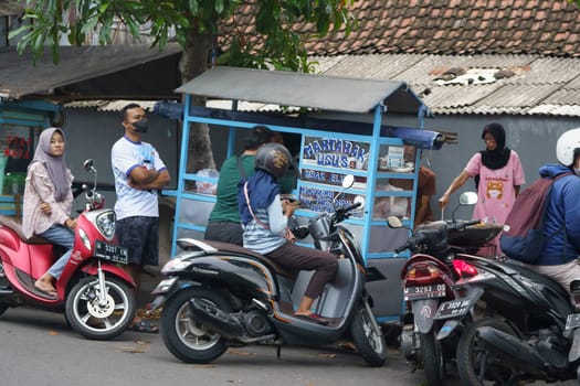 March 26, 2023. People are buying street foods in Gresik, Indonesia.