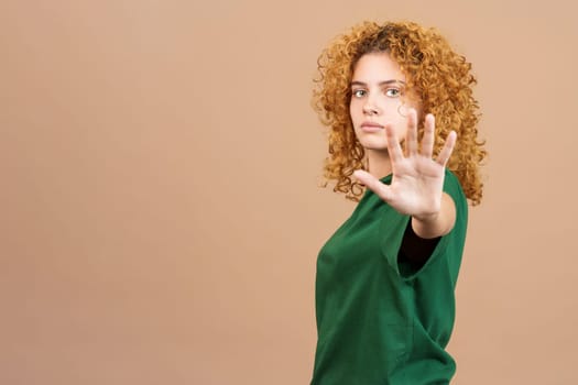 Serious woman gesturing rejection with her hand