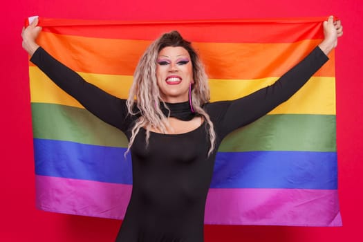 Happy transgender person raising a lgbt rainbow flag