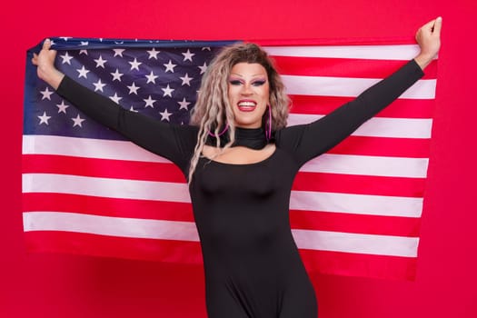 Happy transgender person raising a north america national flag