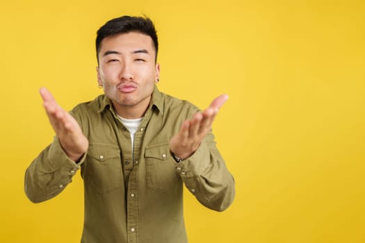 Chinese man blowing a kiss while looking at the camera