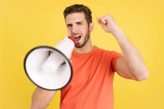 Upset caucasian man yelling using a loudspeaker