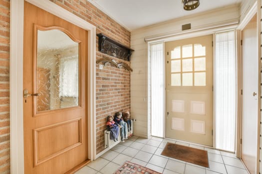 the entryway of a house with two children sitting
