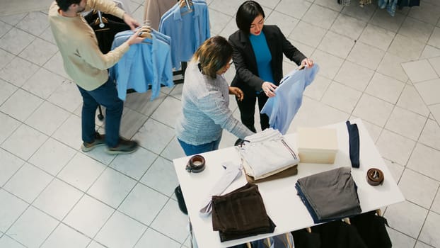 Multiethnic group of people buying clothes in retail store