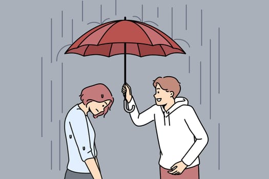 Caring man cover unhappy woman with umbrella
