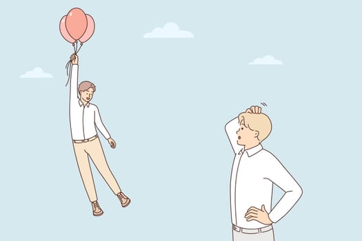 Frustrated man look at colleague flying on balloons