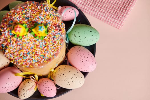 Cropped view of Easter cake with selective focus on colorful eggs on red napkin over pink background. Celebration of Orthodox and Catholic Easter in spring. Christianity. Religious Christian holiday