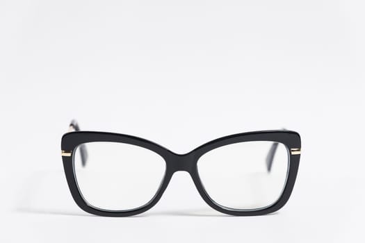 Black female eyeglasses isolated on white background close-up, fashionable trendy stylish accessory