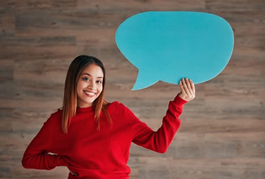 Business woman, speech bubble and smile by wall in portrait with opinion, social media mockup and workplace. Businesswoman, paper and poster for news, announcement and happy with sign, vote and voice