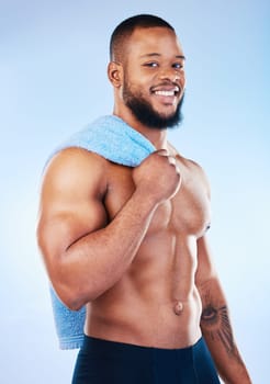 Black man, portrait and body towel with a smile in studio for health, wellness and fitness. Face of healthy male aesthetic model with clean skin, strong muscle and happiness on a blue background