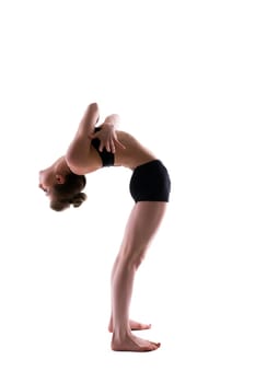 Slender flexible gymnast posing in studio
