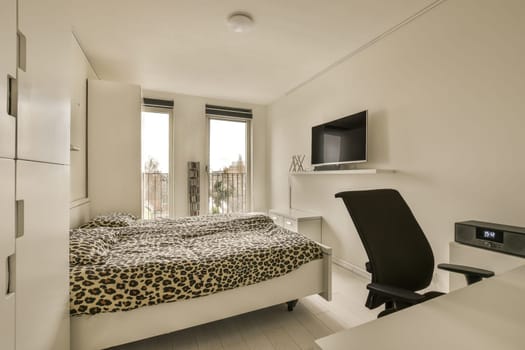 a bedroom with a leopard bed and a desk