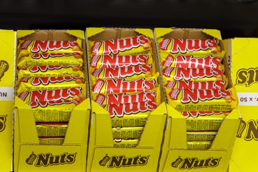 Tyumen, Russia-March 22, 2023: Nuts chocolate bar from the Nestle company. Grocery store shelves