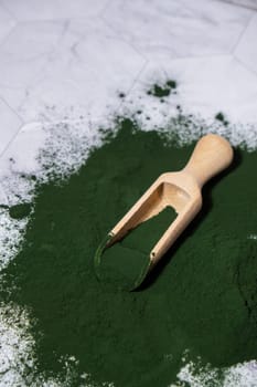 Blue-green algae Chlorella and spirulina powder with wooden spoon. Super powder. Natural supplement of algae. Detox superfood drink cocktail. Food supplement source of protein and beta carotene
