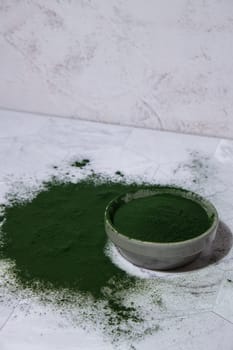 Blue-green algae Chlorella and spirulina powder in bowl. Super powder. Natural supplement of algae. Detox superfood drink cocktail. Food supplement source of protein and beta carotene