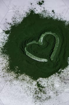 Heart on Blue-green algae Chlorella and spirulina powder. Super powder. Natural supplement of algae. Detox superfood drink cocktail. Food supplement source of protein and beta carotene
