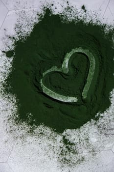 Heart on Blue-green algae Chlorella and spirulina powder. Super powder. Natural supplement of algae. Detox superfood drink cocktail. Food supplement source of protein and beta carotene