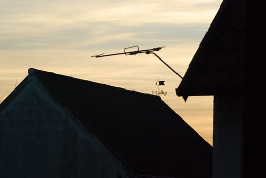 Silhouettes of house roofs with a weather vane in Bredelem, Germany