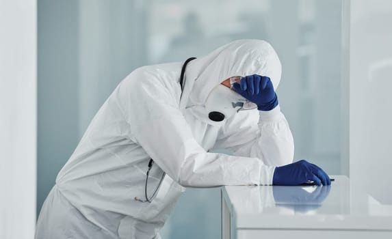 Tired doctor scientist in lab coat, defensive eyewear and mask takes break
