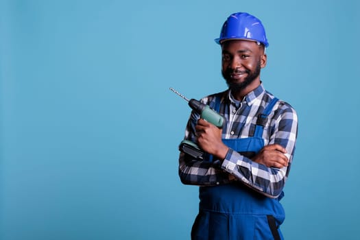 African american builder wearing hard hat and coverall