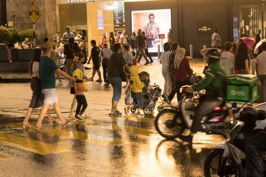 March 2, 2023. Bukit Bintang, Malaysia. People crossing the street at night.