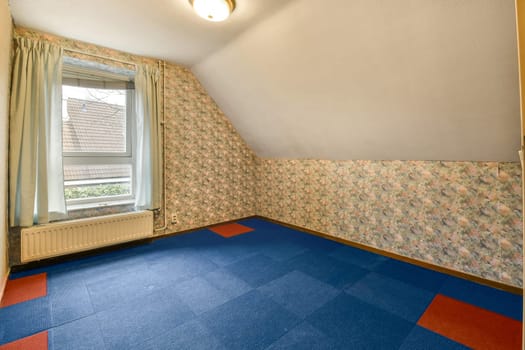 a room with a blue carpet and a window