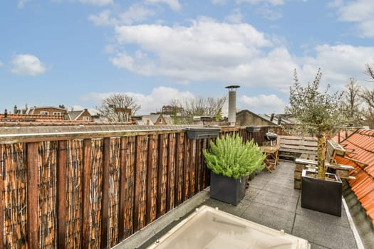 the rooftop deck with a hot tub and a wooden