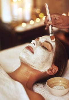 Want flawless skin. a young woman enjoying a facial treatment at the spa.