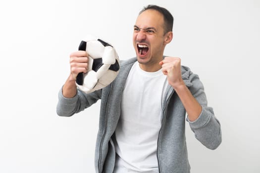 Handsome man holding a soccer ball. High quality photo