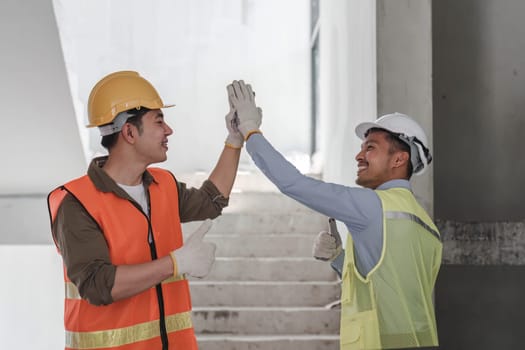 Businessman handshake with engineering in construction renovate building site. Engineer or architect inspection workplace for project.Teamwork construction engineer,business and architecture concept.