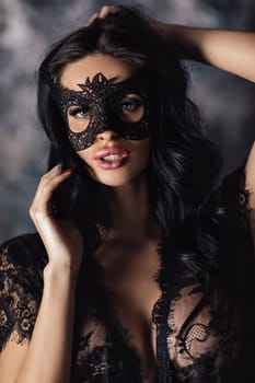 portrait of sexy beautiful woman in lace lingerie and carnival mask