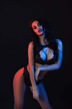 Sexy woman in lace black sensual lingerie with long curly hair