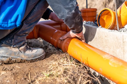 installation of a sewage plastic pipe during the construction of a house