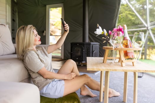 woman with smartphone in geo dome tent