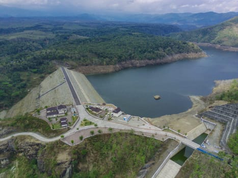 Aerial view of water dam against the hills and trees