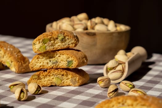 Biscotti Cantuccini Cookie Biscuits with pistachios and lemon peel Shortbread. Healthy eating food. Homemade fresh Italian cookies cantucci stacks and organic pistachios nuts. Vegan dieting