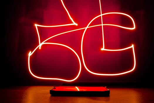 Abstract red lines long exposure light shape of 5G. Network internet mobile wireless Innovations in the future 5G cellular and Internet speeds.