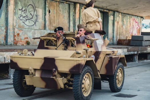 Hel, Poland - August 2022 Military troops marching during 3 May Polish Constitution Day ceremonial patriotic parade. Old guns and cars. Feast of Polish Armed Forces Day, American soldiers with flag on parade Nato Vehicles Military Equipment
