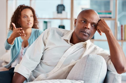 Couple, fight and ignore on sofa for problems, breakup and bad communication in lounge. Divorce, crisis and frustrated people in conflict, angry partner and betrayal of cheating, drama and depression.