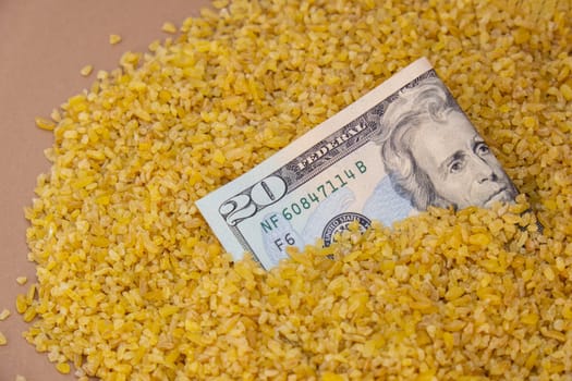 US Dollar bill paper money currency banknote in buckwheat porridge. The crisis in the market of grain crops, the rise in prices or production volumes of buckwheat Food and groceries shopping price increase inflation